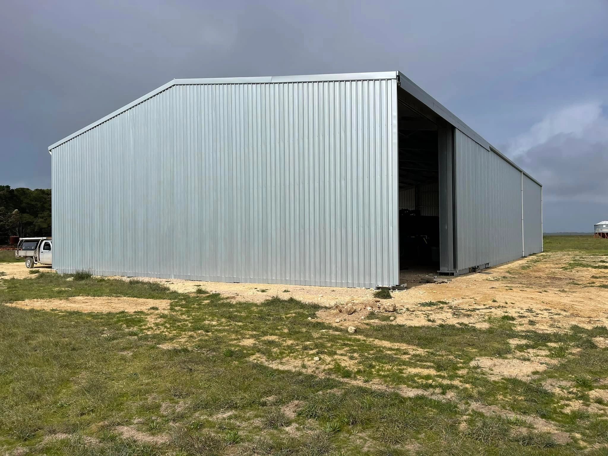 Large white metal agricultural shed